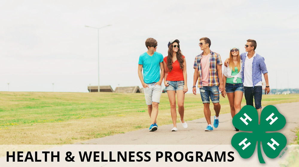 A group of youth walking along a path with the text Health & Wellness Programs and 4-H clover overlaid