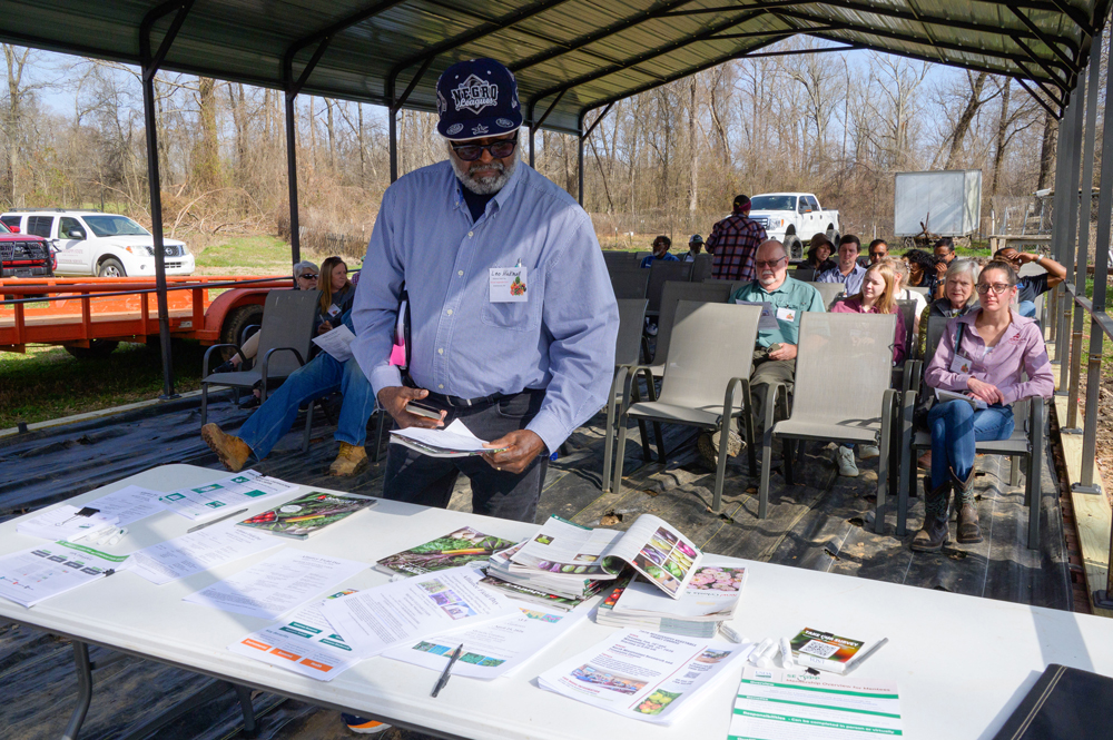A person picks up papers from a table.