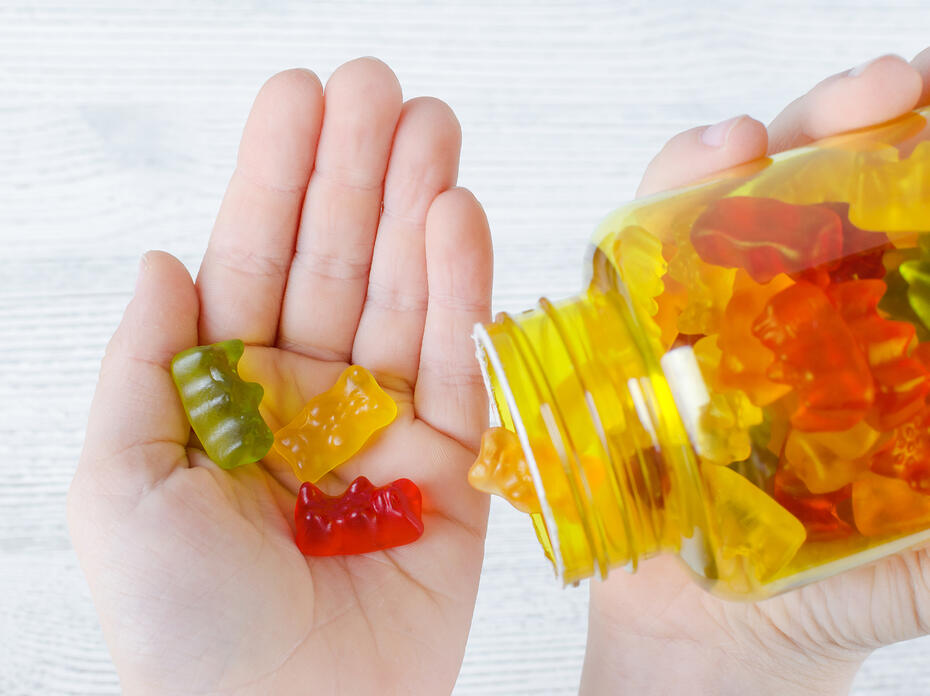 Closeup of gummy vitamins in a child’s hand