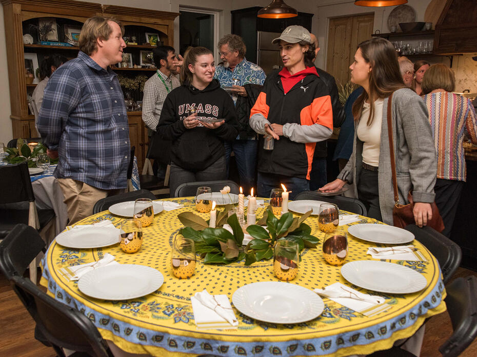 A group gathers around a decorated table.