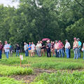 A large group of people standing in a field.