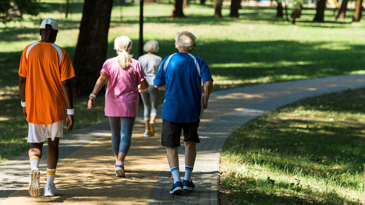 Four people walking in a park
