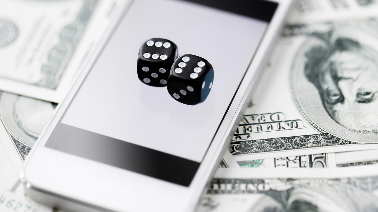A phone screen displays an image of two dice.