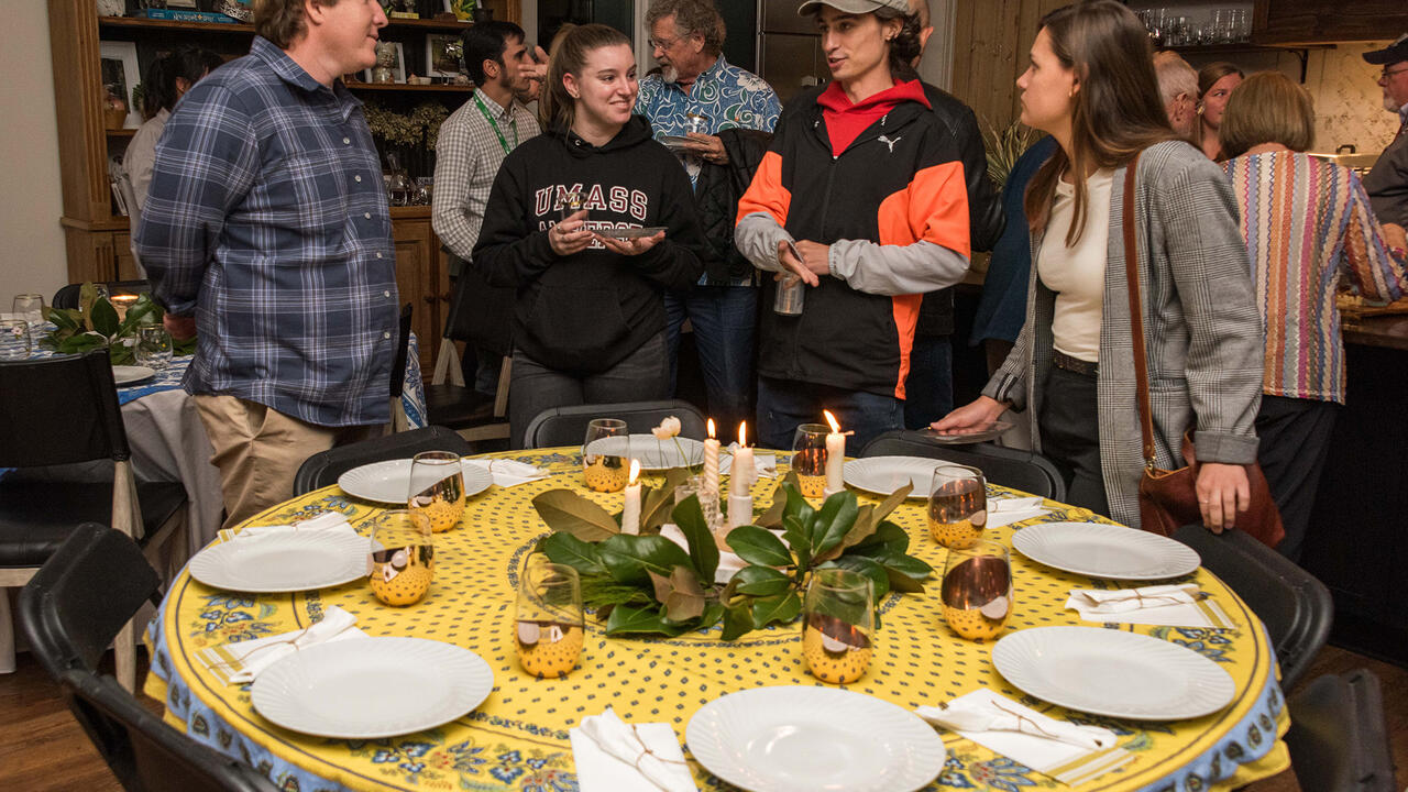 A group gathers around a decorated table.