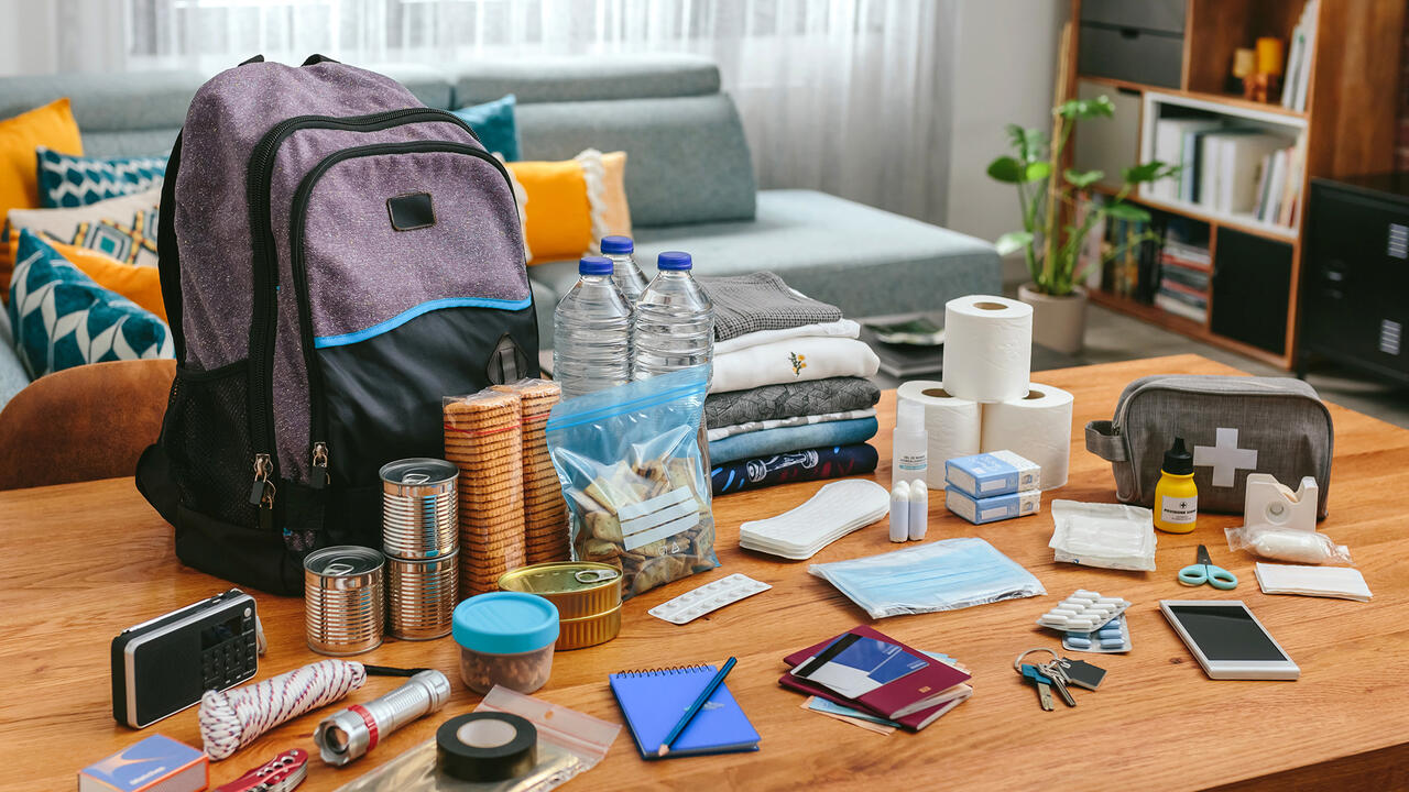 Items for a disaster kit are displayed on a coffee table.