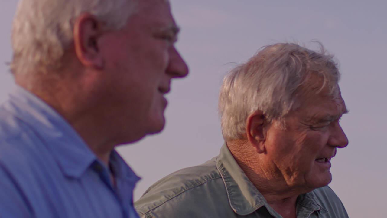 Two men are photographed outdoors.