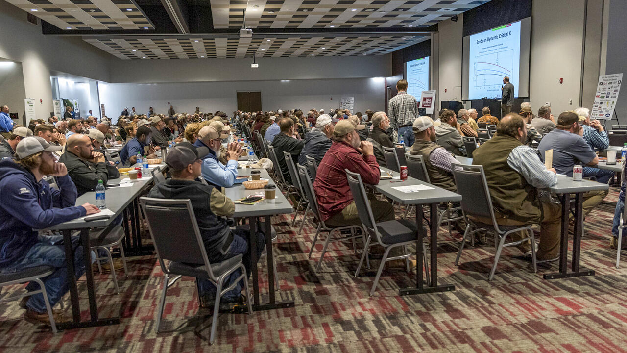 A large room full of people watching a presentation.