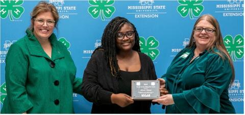 Dr. Mariah Morgan and Connie Darden present Akeah Mayes with an award