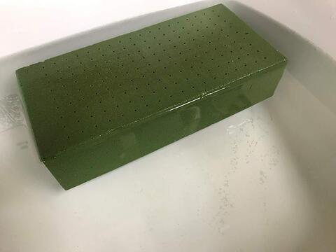 The foam brick fully submerged in water. 