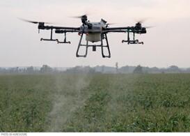 Drone spraying crops.