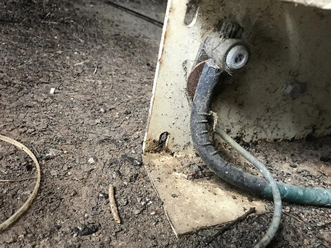 One large and one small ground wire attached to an angle iron generator frame.
