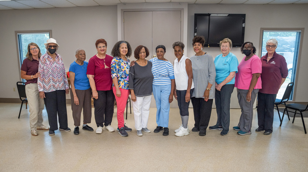A group of twelve women standing in a row.